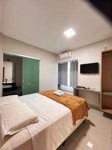 Ένα ή περισσότερα κρεβάτια σε δωμάτιο στο Capitólio Home Suítes +47 φωτογραφίες