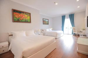 Postel nebo postele na pokoji v ubytování Hotel Du Lys