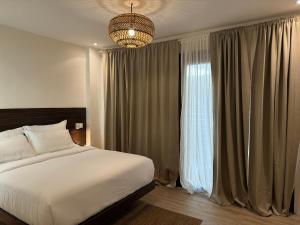a bedroom with a bed and a large window at Caracoa Resort in General Luna
