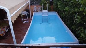 an empty swimming pool in a backyard at Holiday Home Villa Relax in Palermo