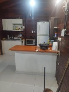 a kitchen with a counter top and a refrigerator at Cabaña Madreselva in Colonia Benítez