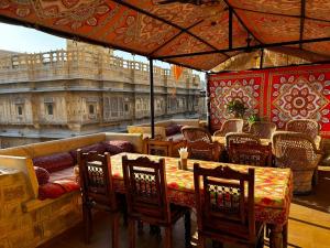 a restaurant with a table and chairs with a view of the city at Killa Bhawan Lodge in Jaisalmer