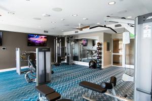 a fitness room with a gym with tread machines at 3 Miles to Disney Heated Pool CnvntnCtr Jacuzzi in Fullerton