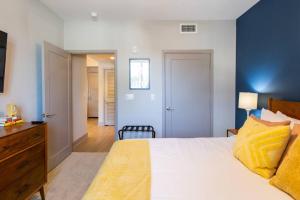a bedroom with a bed and a dresser and a room at 3 Miles to Disney Heated Pool CnvntnCtr Jacuzzi in Fullerton +41 photos