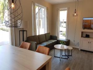 a living room with a couch and a table at Modern Villa with Garden in Almen