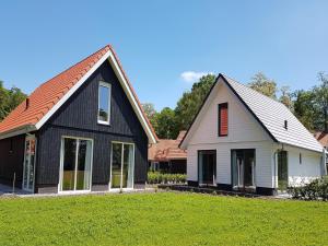 a black and white house with a red roof at Modern Villa with Garden in Almen