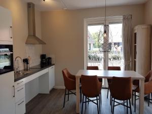 a kitchen and dining room with a table and chairs at Modern Villa with Garden in Almen