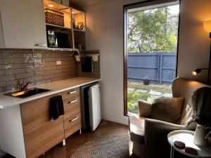 a kitchen with a sink and a chair and a window at Cosy & Pet-friendly Blackheath Studio 3 in Blackheath