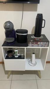 a white shelf with a coffee maker and a pot on it at Quarto privativo próxima a Arena Opus in São José