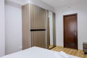 Ένα ή περισσότερα κρεβάτια σε δωμάτιο στο Exclusive 1BR at Serpong M-town Signature Apartment By Travelio +14 φωτογραφίες
