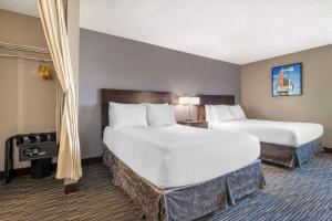a hotel room with two beds in a room at Best Western McCarran Inn in Las Vegas