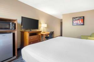 a hotel room with a bed and a flat screen tv at Best Western McCarran Inn in Las Vegas