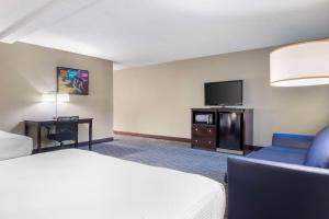 a hotel room with a bed and a flat screen tv at Best Western McCarran Inn in Las Vegas