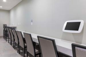a conference room with a row of chairs and a tv at Best Western McCarran Inn in Las Vegas
