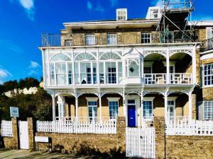 a large brick building with a white fence at Flat 3 Marine Parade House, 1 East Cliff - Next to Dover Port, White Cliffs, Beach, Castle in Dover