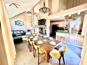 a dining room and kitchen with a wooden table and chairs at Lake Harmony 4bdrm Ski pool hot tub lake in Lake Harmony
