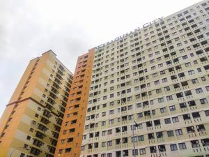 two tall apartment buildings in front of each other at Comfy and New Furnished at 2BR Kebagusan City Apartment By Travelio in Jakarta
