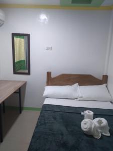 a bedroom with a bed with two towels on it at Thomasita's Homestay in General Luna +6 photos