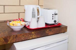 a counter with a coffee maker and a toaster at Augusta Budget Motel in Port Augusta