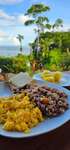 two plates of food with eggs and bread on a table at Cabinas vista isla del caño corcovado in Drake