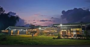 a house with lights in the yard at night at Jorge's Economy Room in Manolo Fortich +3 photos