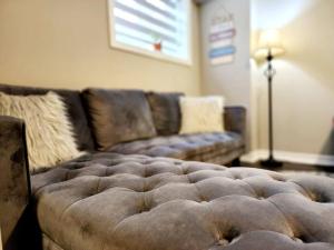 a brown couch in a living room with at 1 Bedroom basement apartment with separate entrance in Milton +16 photos