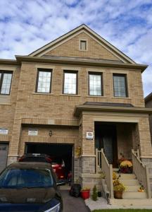 a house with a car parked in front of it at 1 Bedroom basement apartment with separate entrance in Milton