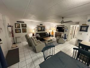 a living room with a couch and a tv at Captain's Quarters in Ocean City
