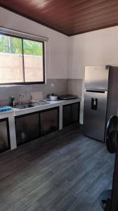 a kitchen with a stainless steel refrigerator and a sink at Jawy's House, Puerto Viejo, Limón in Puerto Limón