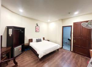 Postel nebo postele na pokoji v ubytování Le Grey Dalat Hotel