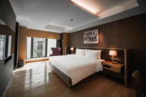 Postelja oz. postelje v sobi nastanitve Grand Metropark Hotel Shanghai Pudong