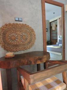 a mirror on a wall with a wooden table at Sandbank Madiha deluxe bedroom with private bathroom in Matara