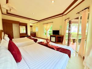 a bedroom with two beds with slippers on them at Lanta Palm Beach Resort , Beach Bungalow - Koh Lanta in Ko Lanta +103 photos