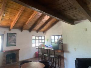 a living room with a table and chairs and a fireplace at La cabaña Gaby in Mazamitla
