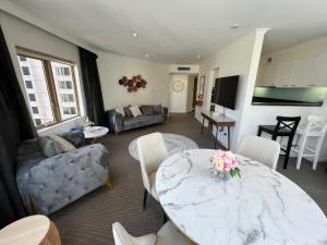 a living room with a marble table and a couch at Fancy home with water view in the rocks in Sydney