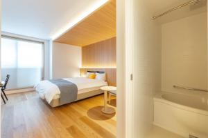 Tempat tidur dalam kamar di Dash Living Gojo