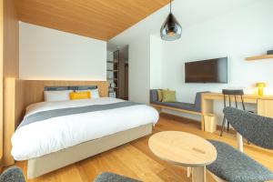 Tempat tidur dalam kamar di Dash Living Gojo