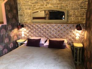 a bedroom with a bed and a mirror on the wall at Les Fleurs De Lys, Suite'Appart , Entrée et Terrasse Privée Proche de la Mer in Saint-Georges-dʼOléron
