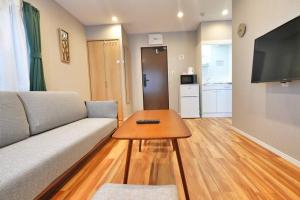 a living room with a couch and a table at ZJ301 Hanama301 The Skytree Residence A Newly Home by Tokyo Iconic Landmarks in Tokyo