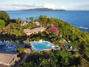 an aerial view of a resort with a swimming pool at Château de feuilles & SPA - Praslin island in Baie Sainte Anne