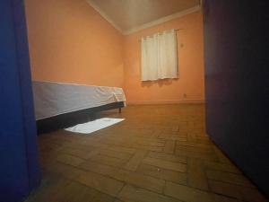 a room with a mattress on the floor and a window at Hotel Palace Econômico in Goiânia