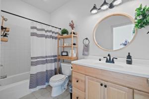 a bathroom with a sink and a toilet and a mirror at Zen Whisper in the Woods in Groveland +27 photos
