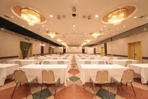 a banquet hall with white tables and chairs at Hotel Anesis Seto-Ohashi in Utazu +20 photos