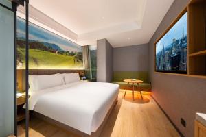 Posteľ alebo postele v izbe v ubytovaní Qiuguo Hotel Chongqing Guanyin Bridge Branch