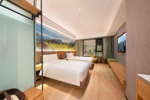 Posteľ alebo postele v izbe v ubytovaní Qiuguo Hotel Chongqing Guanyin Bridge Branch