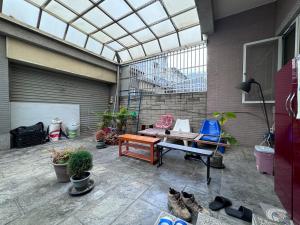 a patio with a bench and a table and some plants at 東海獨角獸 in Longjing +52 photos