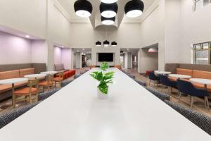 a large conference room with tables and chairs at Hampton Inn & Suites Saginaw in Saginaw