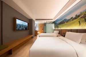 Posteľ alebo postele v izbe v ubytovaní Qiuguo Hotel Chongqing Guanyin Bridge Branch