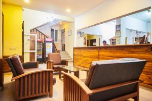 a bar with chairs and a table in a room at Anjary Hotel Mahajanga in Mahajanga