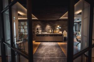 a room with a kitchen with a brick wall at Hotel Ederstrand in Frankenberg